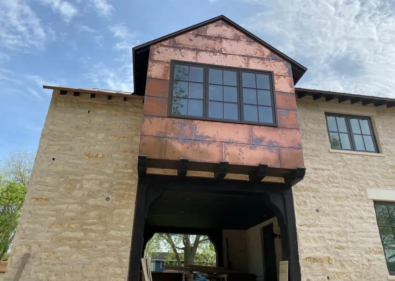 Copper metal panel facade on a stone building for Skylight Installation in West Vincent